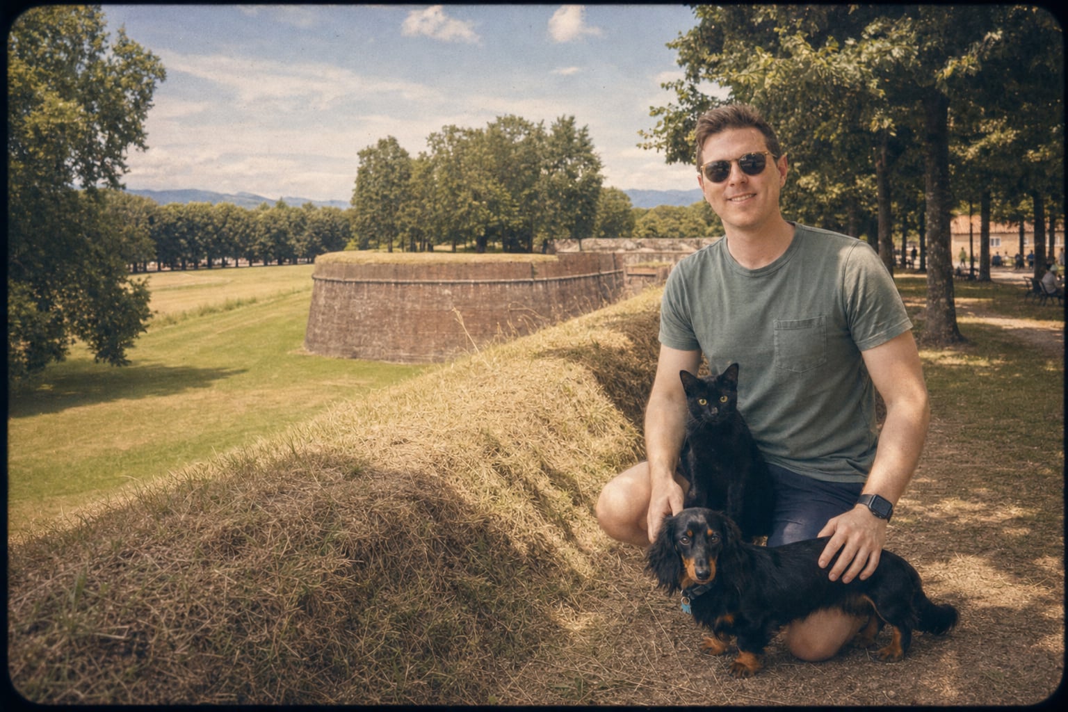 The black cat judges the fortifications; the man smiles anyway.
