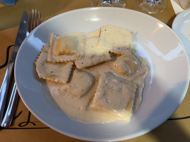 the man brought Aidan his pasta then turned to me and said “come with me” 
…?
points me to his wife inside the door who has a wheel of Parmesan, lights a pan of oil on fire, then pours it into the cheese with fresh truffles to make my sauce. 
Yum.